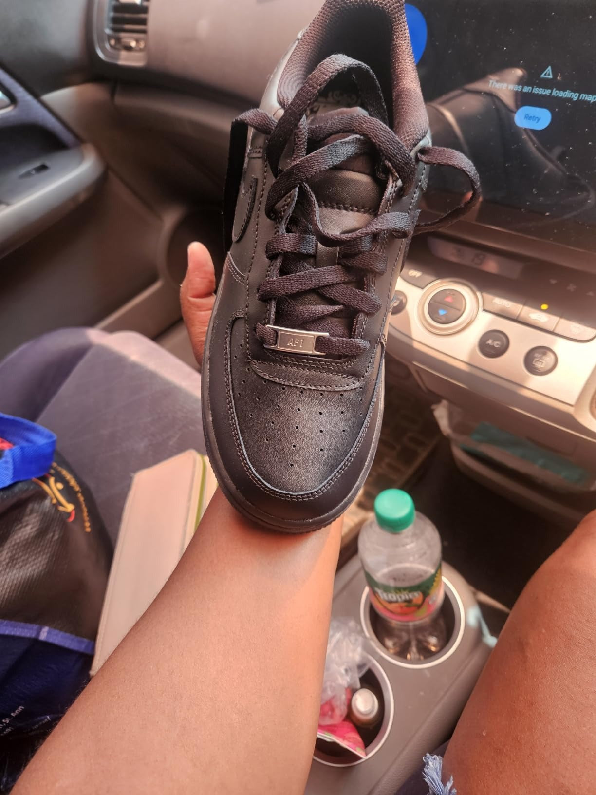 A black Nike Air Force 1 sneaker 
