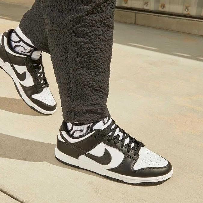 A person wearing black and white Nike 