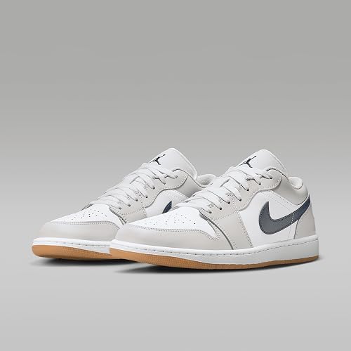 White sneakers with a gray swoosh logo on a light gray background
