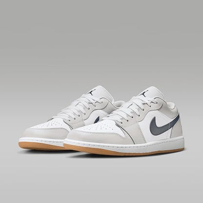 White sneakers with a gray swoosh logo on a light gray background